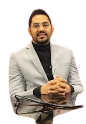 Dr. Krishna Singh, a pulmonologist from Bhopal, wearing a formal grey suit while sitting at a table.